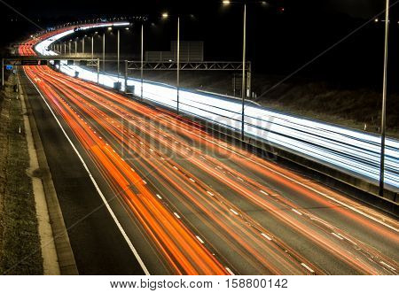 British M1 motorway at night with white and red lights trails