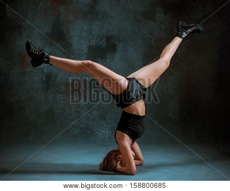 Attractive girl dancing twerk iat the blue studio background