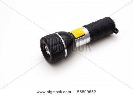 small black flashlight on a white background