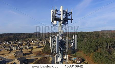 Aerial view of cell phone tower over neighborhood