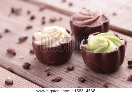 diffrent kinds of chocolate candy on wooden table