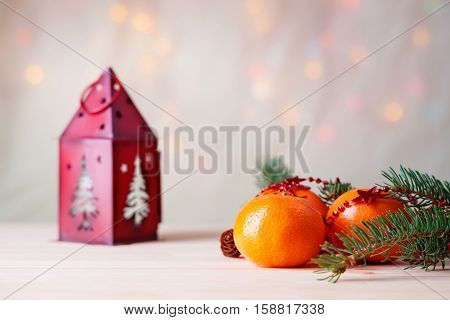 Mandarins with fir-tree branch and house shaped candlestick