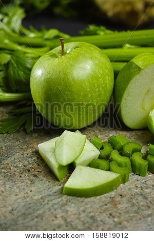 Green vegetables and fruits - celery shoots and apples healthy fitness diet concept