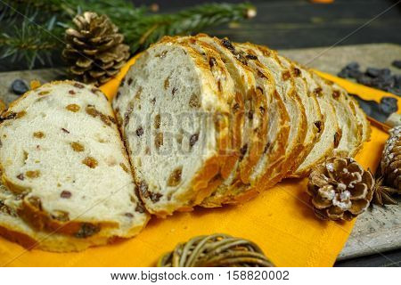 Fresh baked raisins bread sliced on granite board holiday concept