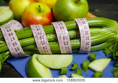 Green vegetables and fruits - celery shoots and apples healthy fitness diet concept