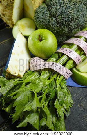 Green vegetables and fruits - celeriac broccoli celery shoots and apples healthy fitness diet concept