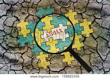 Word Audit written under a magnifier on abstract background