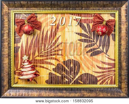 Beautiful Christmas background with balls on the table with leaves the in the frame of the picture