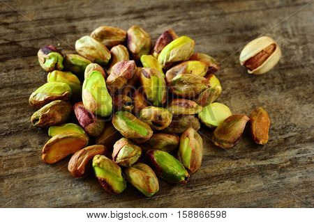 Close-up image of pistachios on wooden background