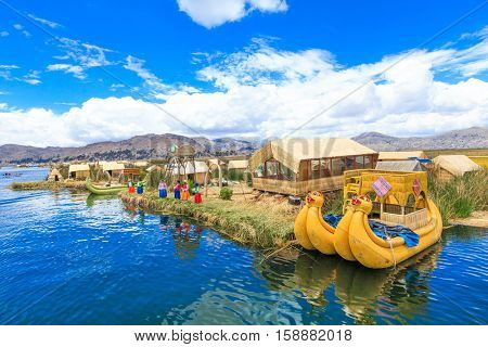 PERU - MAY 11, 2015: Unidentified women in traditional dresses welcome tourists in Uros Island