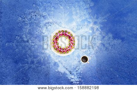 Jelly cake on a white plate coffee cup with coffee all on snow. For greetings postcard. Winter mood.