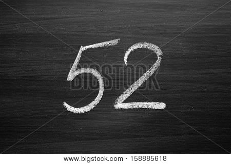 number fifty two enumeration written with a chalk on the blackboard