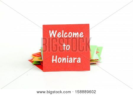 picture of a red note paper with text welcome to Honiara