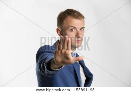 Businessman holding hand up and saying Stop