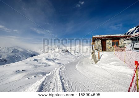 Alpine winter mountain landscape. French Alps covered with snow in sunny day. Val-d'Isere, France