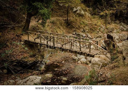 a bridge over a small creek in a gorge of creta
