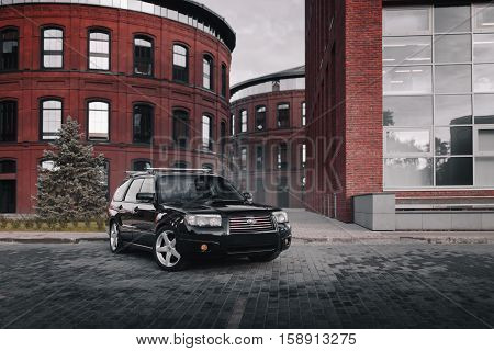 Moscow, Russia - September 25, 2016: Black Car Subaru Forester Parked Near Modern Red Buildings In M