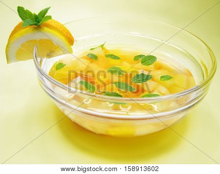 fruit cruchon cocktail punch in bowl with ice and fruit