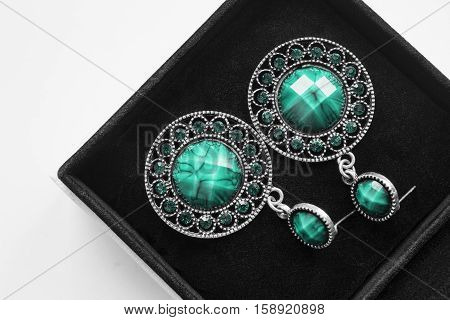 Turquoise vintage earrings in black jewel box closeup