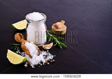 Large crystals of salt with spices on a dark background. Selective focus.
