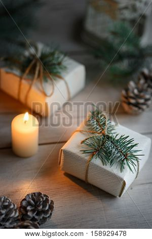 Boxes with Christmas presents on wooden surface against defocused lights