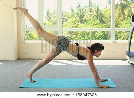 Portrait of young attractive woman doing exercises. Brunette with fit body on yoga mat. Healthy lifestyle and sports concept. Series of exercise poses. Isolated on white