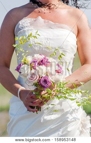 Wedding bouquet with white roses in arms