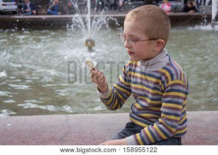 Boy sitting and looking at ice cream