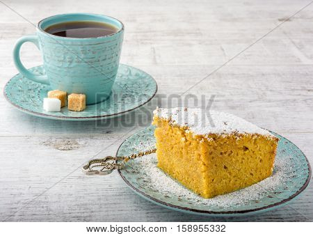 pumpkin pie and tea on a white wooden table