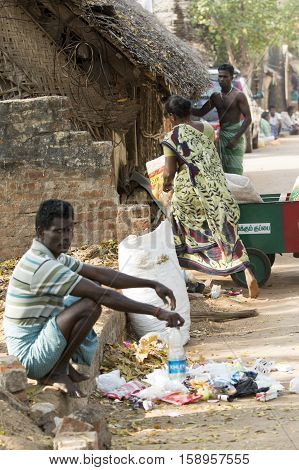 Illustrative image. Pondicherry, Tamil Nadu, India - March 03, 2014. Household waste pastic pick up in the village. Women workers Plastic bottles, papers, bin