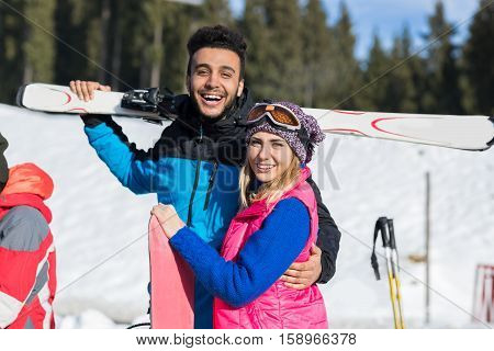 Coupe Ski And Snowboard Resort Winter Snow Mountain Hispanic Man And Woman Embrace Holiday Extreme Sport Vacation