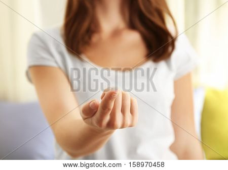 Woman holding contact lens, closeup