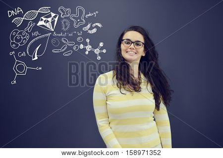 Young smiling woman on blue gray background with universum icons. Confusion.