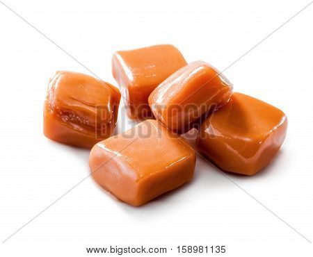 slightly melted toffee caramel candy close-up isolated (with clipping path) on white background