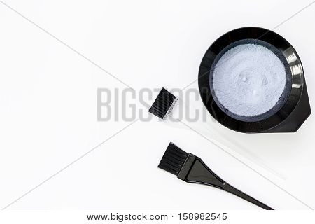 Tools for hair dye and hairdye top view on white background