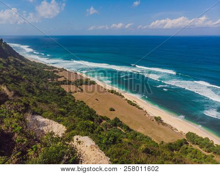 Top Aerial View Of Beauty Bali Beach. Empty Paradise Beach, Blue Sea Waves In Bali Island, Indonesia