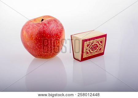 Red Apple And  Islamic Holy Book Quran In Mini Size