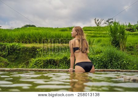 Young Woman Tourist In Belulang Hot Springs In Bali On The Background Of Rice Terraces