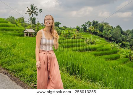 Young Woman Traveler On Beautiful Jatiluwih Rice Terraces Against The Background Of Famous Volcanoes