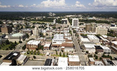 Blue Skies With Soft White Clouds Appear In The Horizon Over The Landscape Of Downtown Macon Georgia