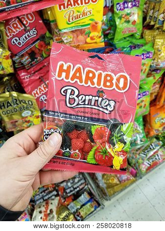 Plattsburgh, Usa - September 10, 2018: A Man Holding Haribo Berries Pack. Haribo Is A German Confect