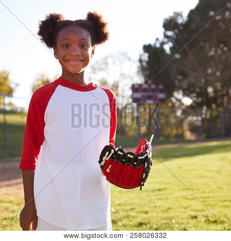Young Black girl with baseball mitt, smiling, square format