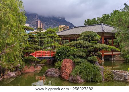 Monaco, Monte Carlo - October 13, 2013: Japanese Garden Or Jardin Japonais With Residential Building