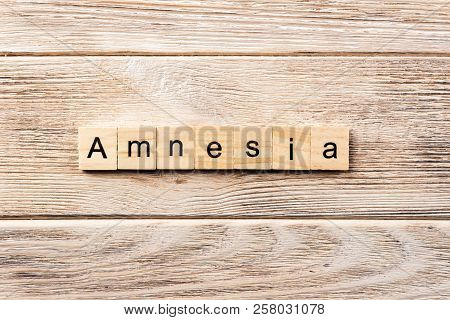 Amnesia Word Written On Wood Block. Amnesia Text On Table, Concept.
