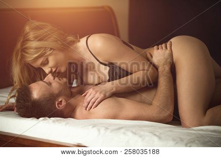 Woman Kissing Man During Intimate Sex. Lovely Couple In The Bedroom