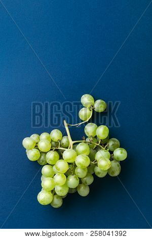 Bunch Of Green Ripe Grape On Dark Blue Background. Top View.
