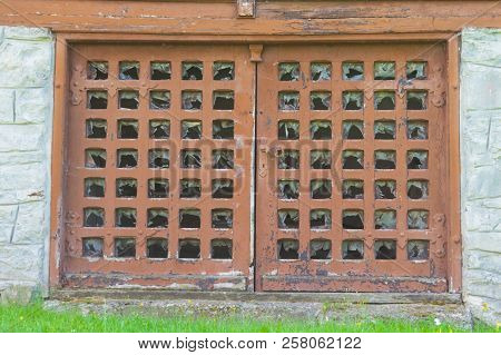 Damaged Basement Doors. Weathered Grungy Brown Wood Doors.