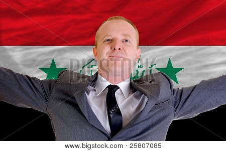 Happy Businessman Because Of Profitable Investment In Iraq Standing Near Flag