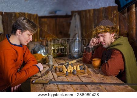 Two Men Playing Popular Strategy Board Game - Tafl