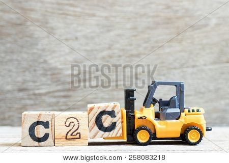 Toy Forklift Hold Letter Block C To Complete Word C2c (abbreviation Of Consumer To Consumer) On Wood